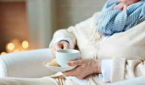 Consultation for home care, woman holding coffee cup