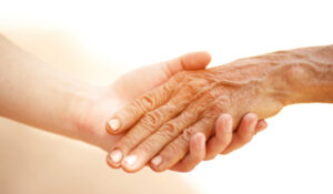 Visiting Lawrence Home Care, elderly hand holding another